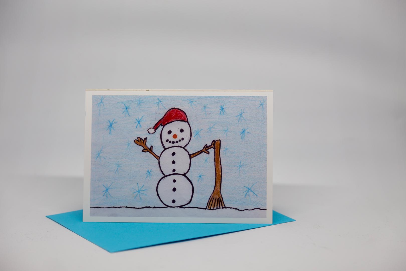 Weihnachtskarte: Schneemann mit Besen