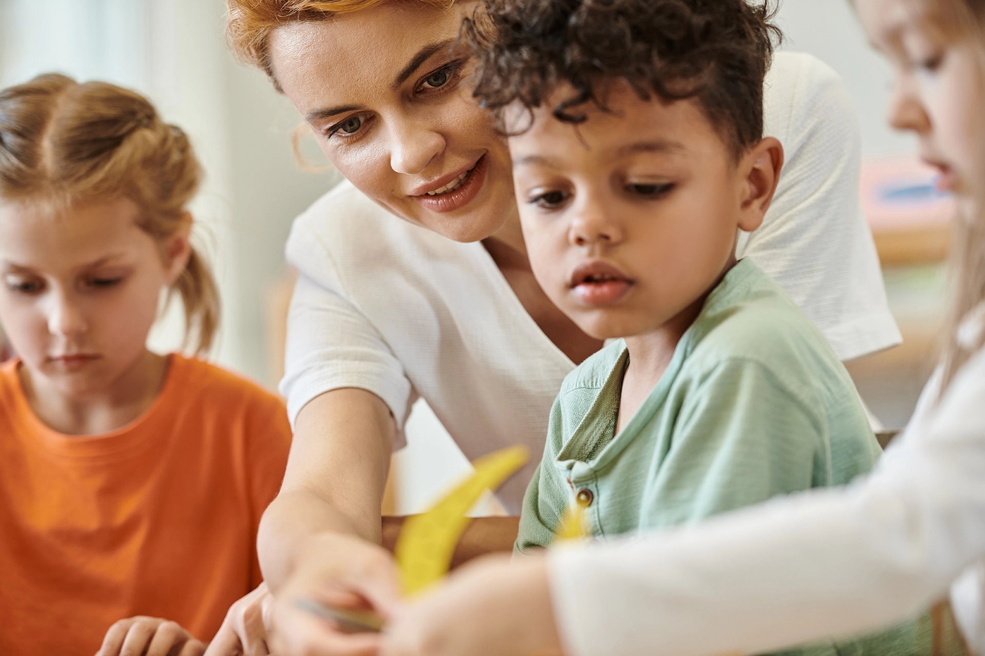 smiling-teacher-talking-to-kid smiling-teacher-talking-to-kid